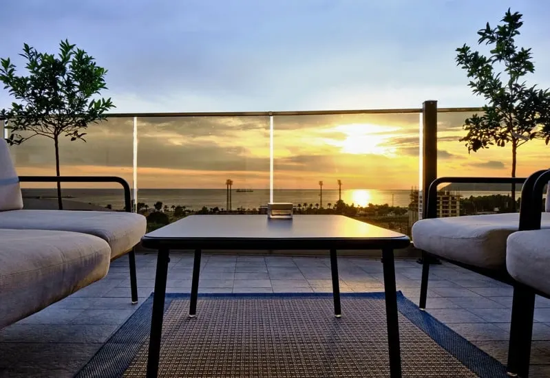 Terrace at sunset, two chairs facing the water
